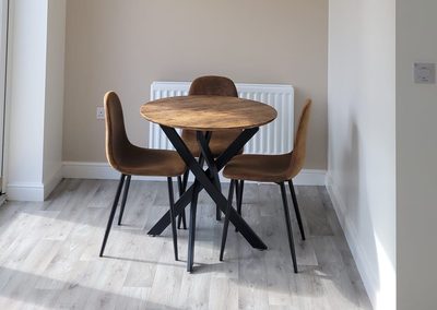 Dining area after decorating, taupe feature wall behind the table