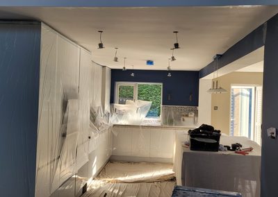 Kitchen before decorating, units sheeted and masked